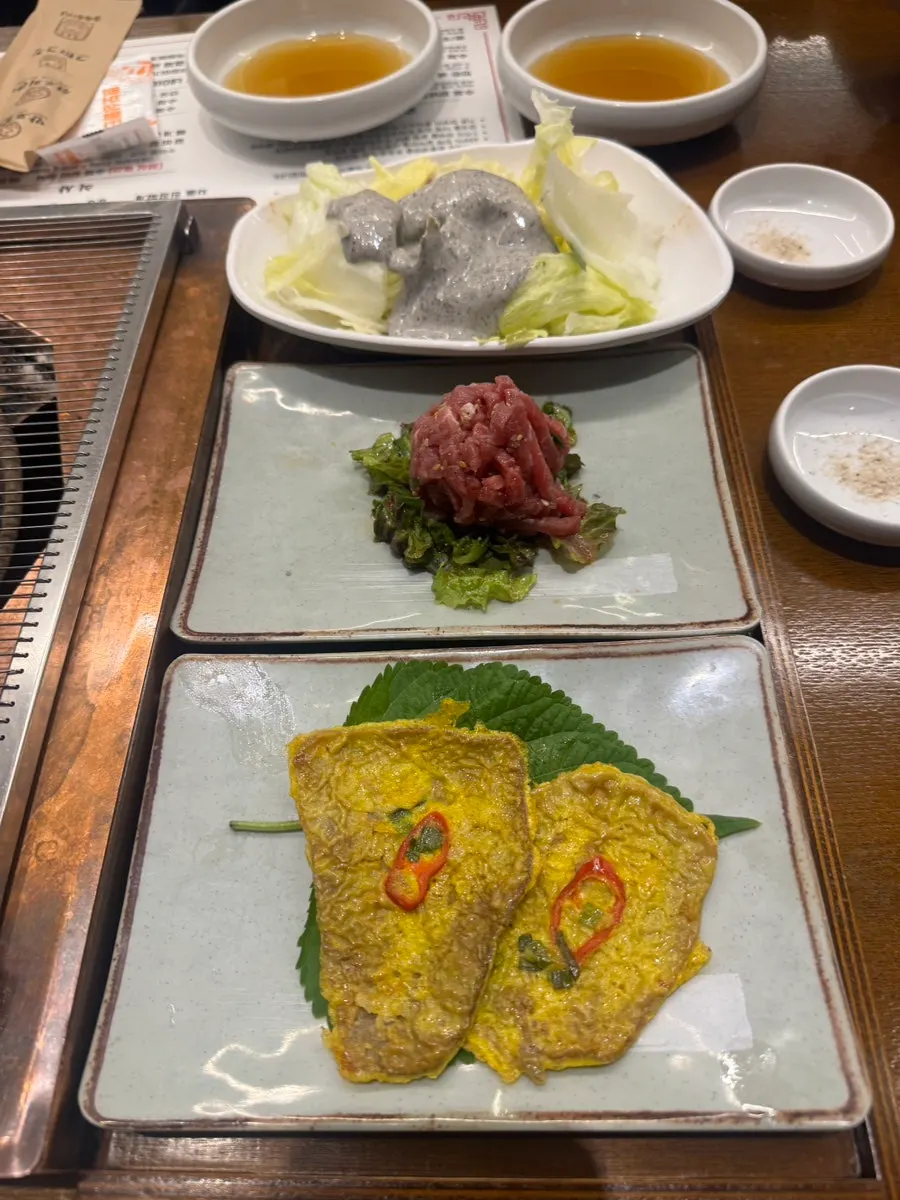 Potato salad, yukjeon, and yukhoe side dishes