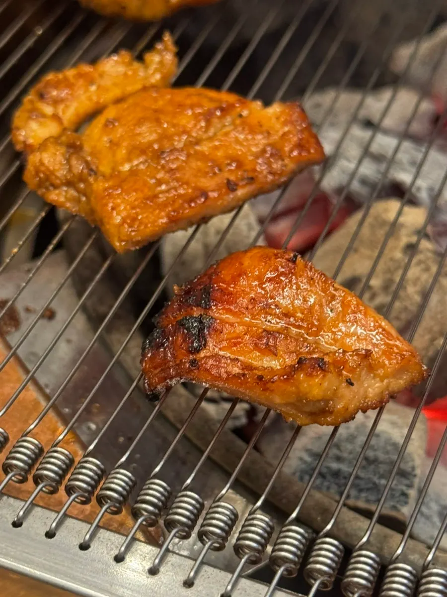 Seasoned galbi grilling on the charcoal pan