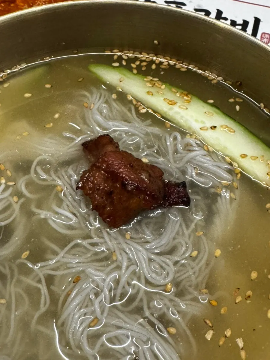 Naengmyeon served alongside the grilled meat
