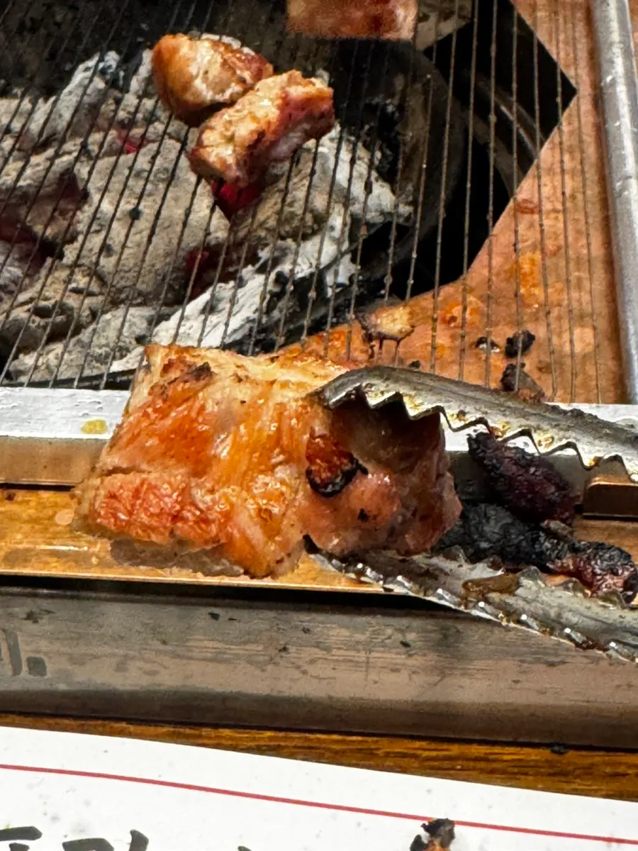 Raw galbi placed on the charcoal grill