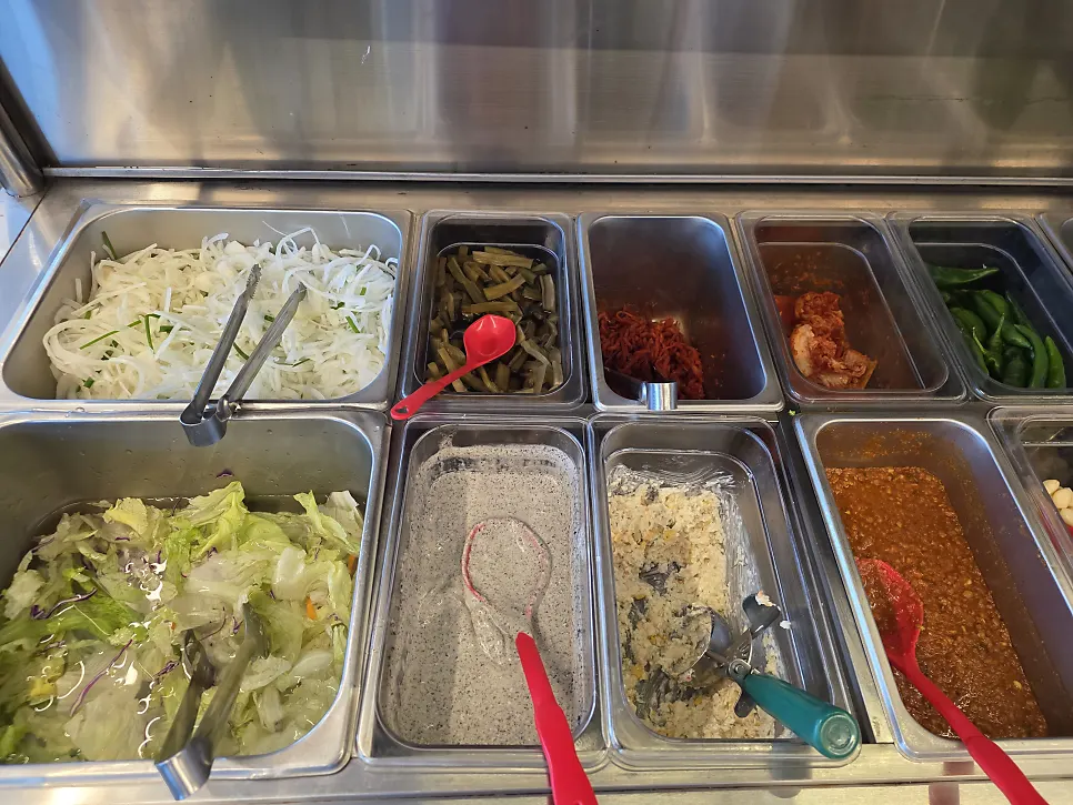 Self-serve banchan bar fully stocked with side dishes