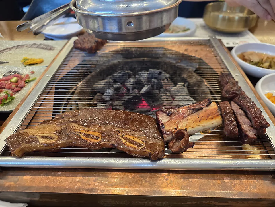 LA galbi cooking on the grill grate