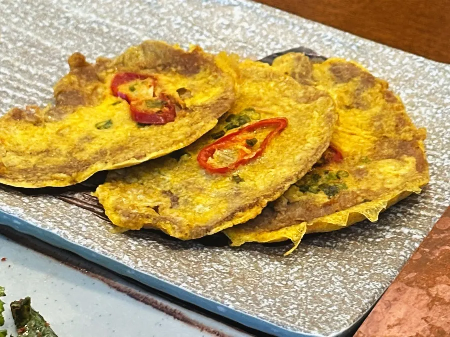 A bite of yukjeon eaten before grilling the meat