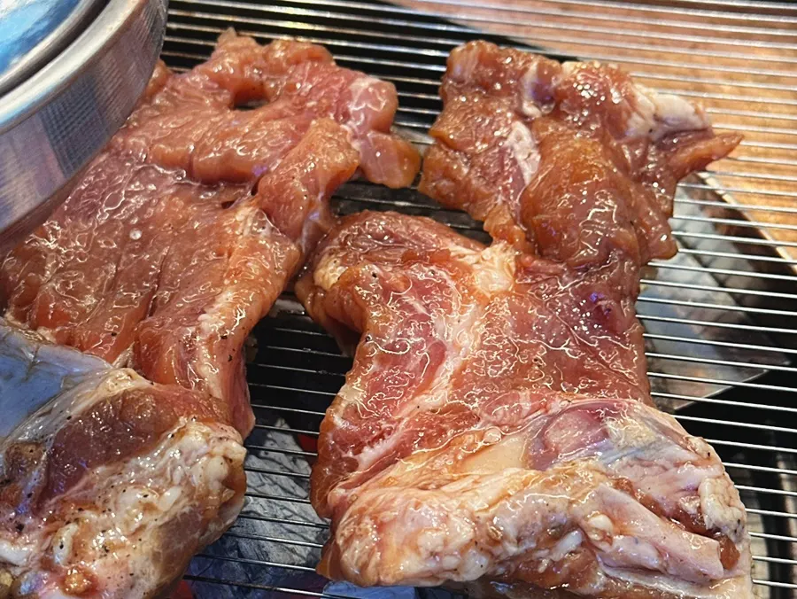 A piece of seasoned pork galbi cooked just right