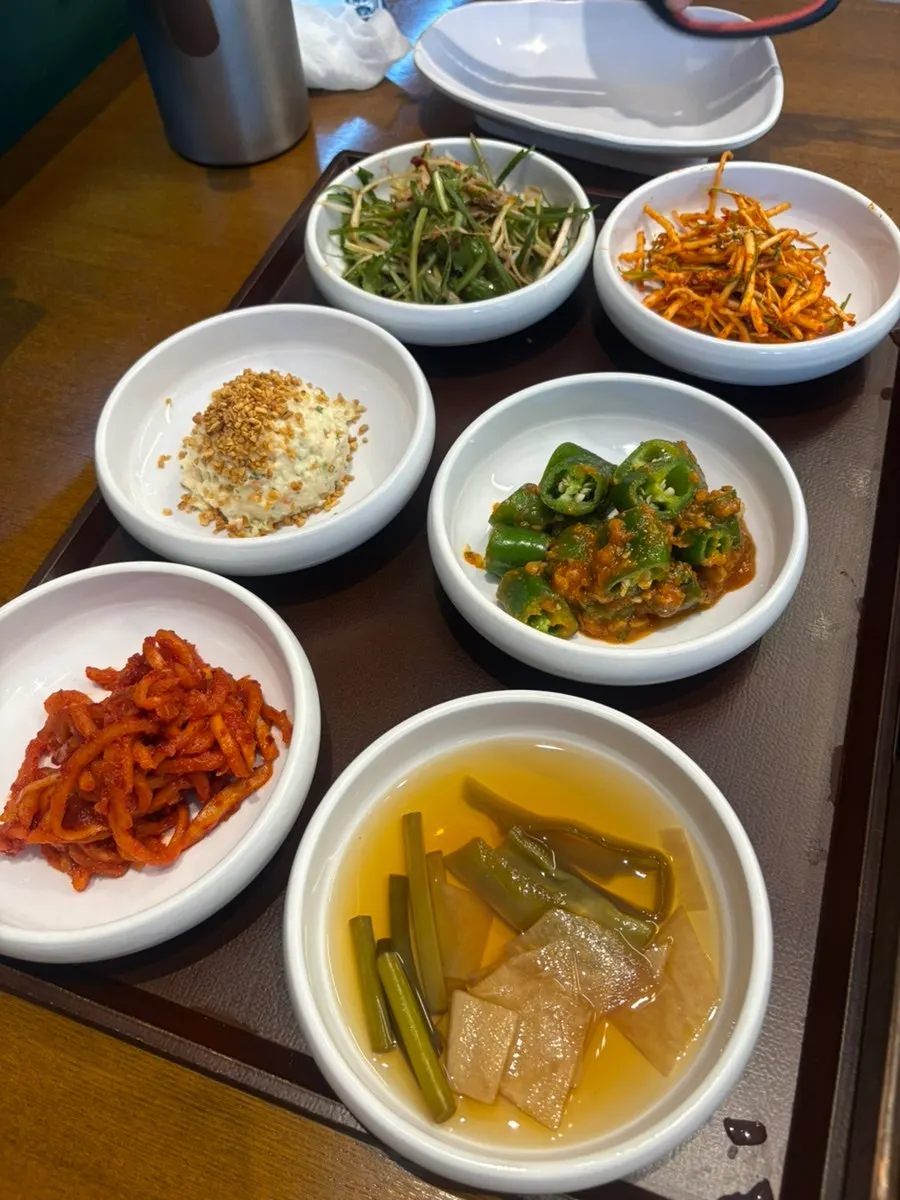 Side dish spread including potato salad and yukjeon