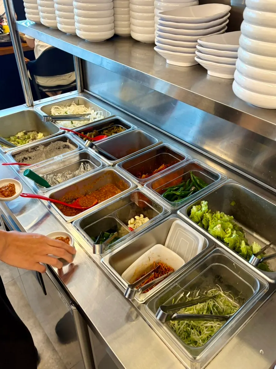 Complimentary yukjeon and black sesame salad