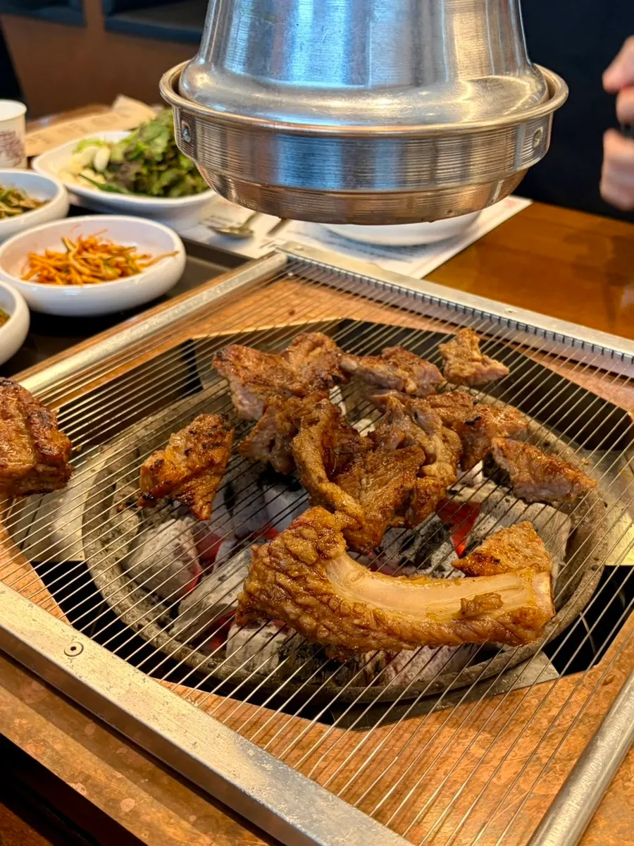 Seasoned galbi placed on the charcoal grill