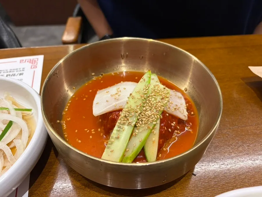 A bowl of naengmyeon, chosen between water and spicy mixed style