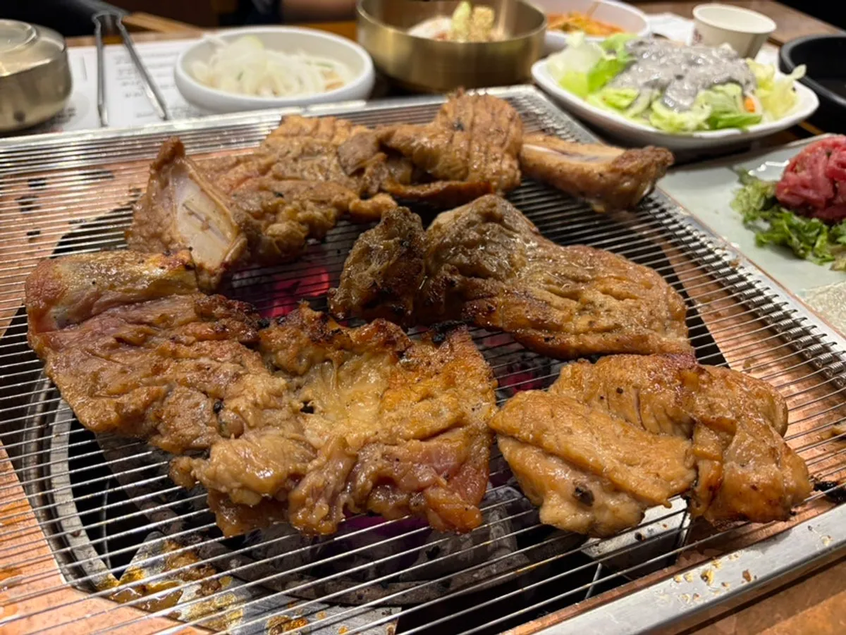 Marinated galbi grilling to a golden brown on the grill