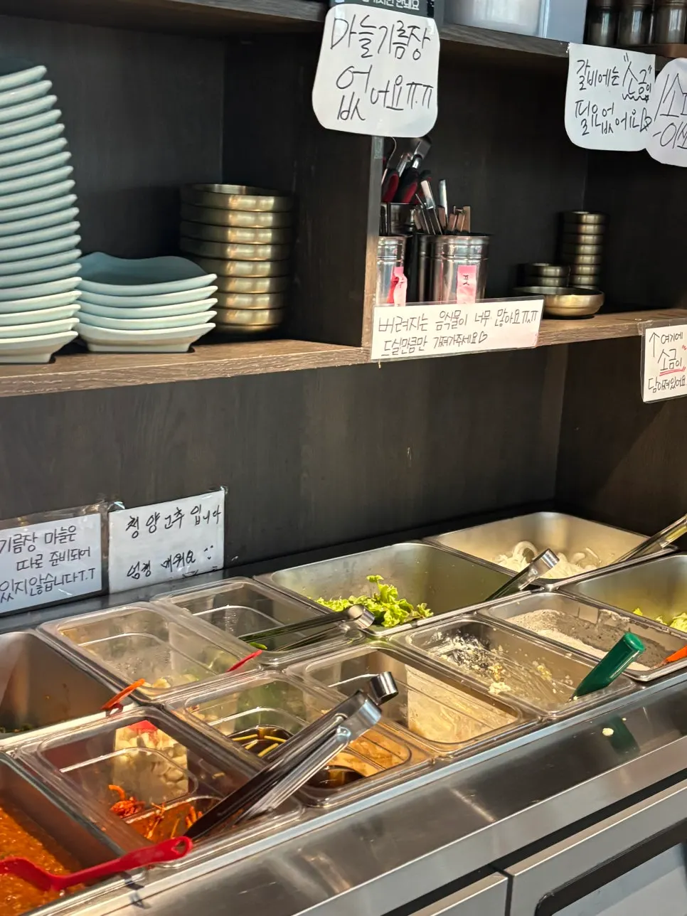 Basic table setting with salad, pickled side dishes, yukjeon, and yukhoe