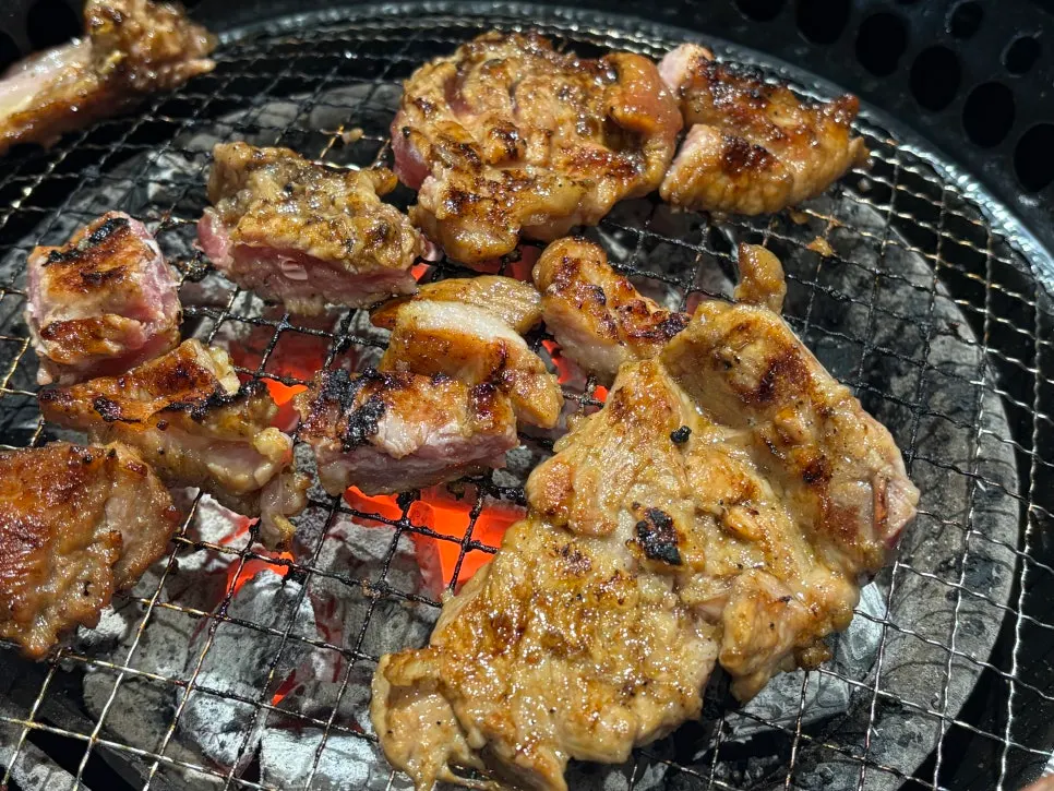 Handmade seasoned pork galbi grilling on the tabletop grill