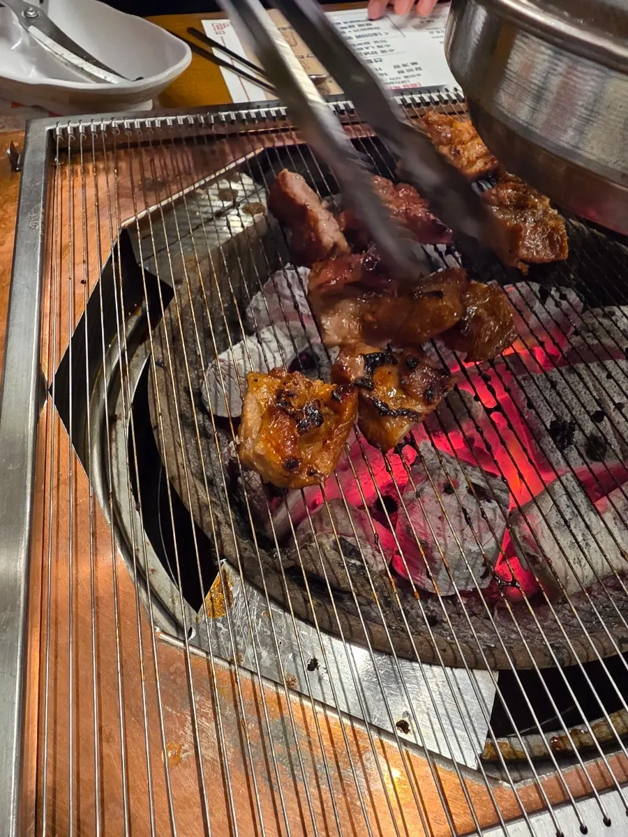 Grilling handmade marinated ribs over charcoal