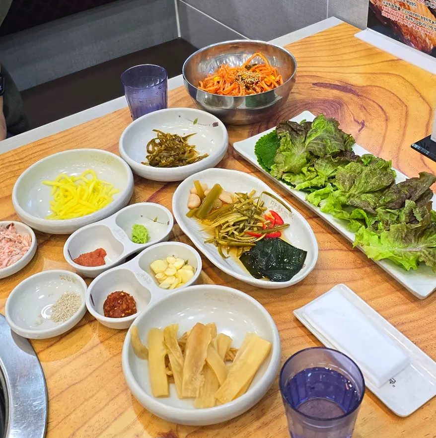 Side dish spread with lettuce wraps and pickles