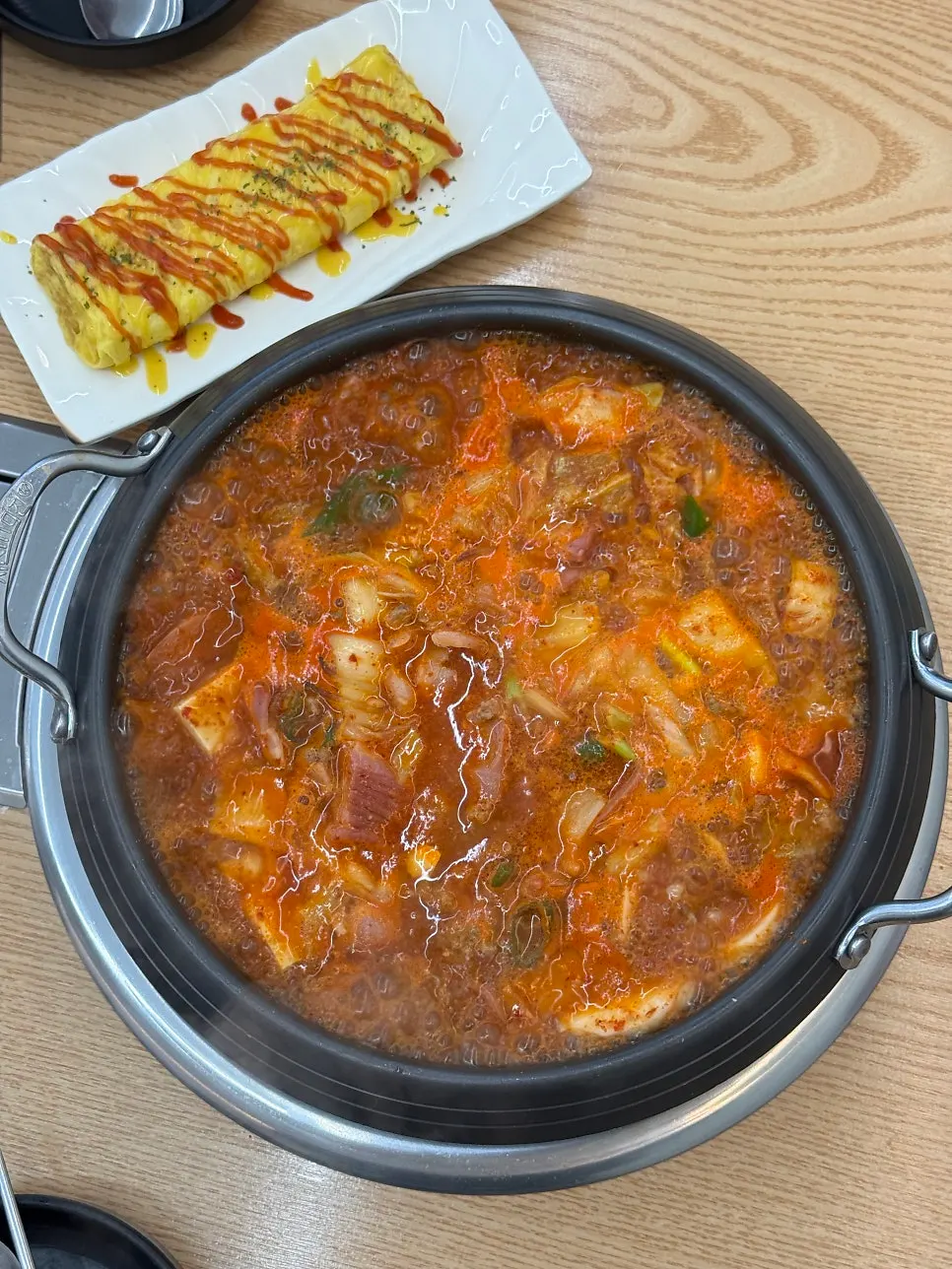 A pot of spicy budae-jjigae bubbling away