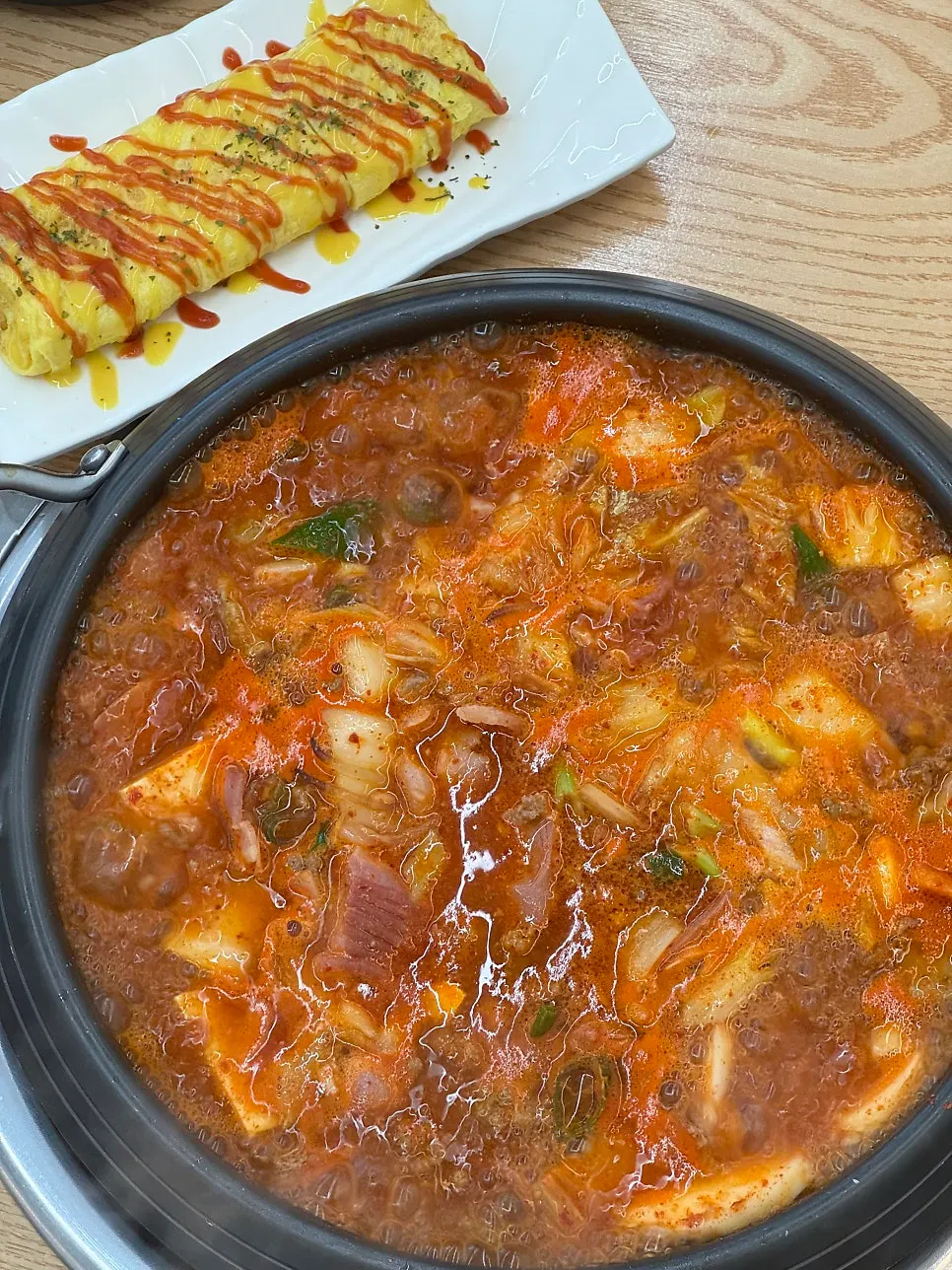 Close-up of budae-jjigae with seasoning stirred in