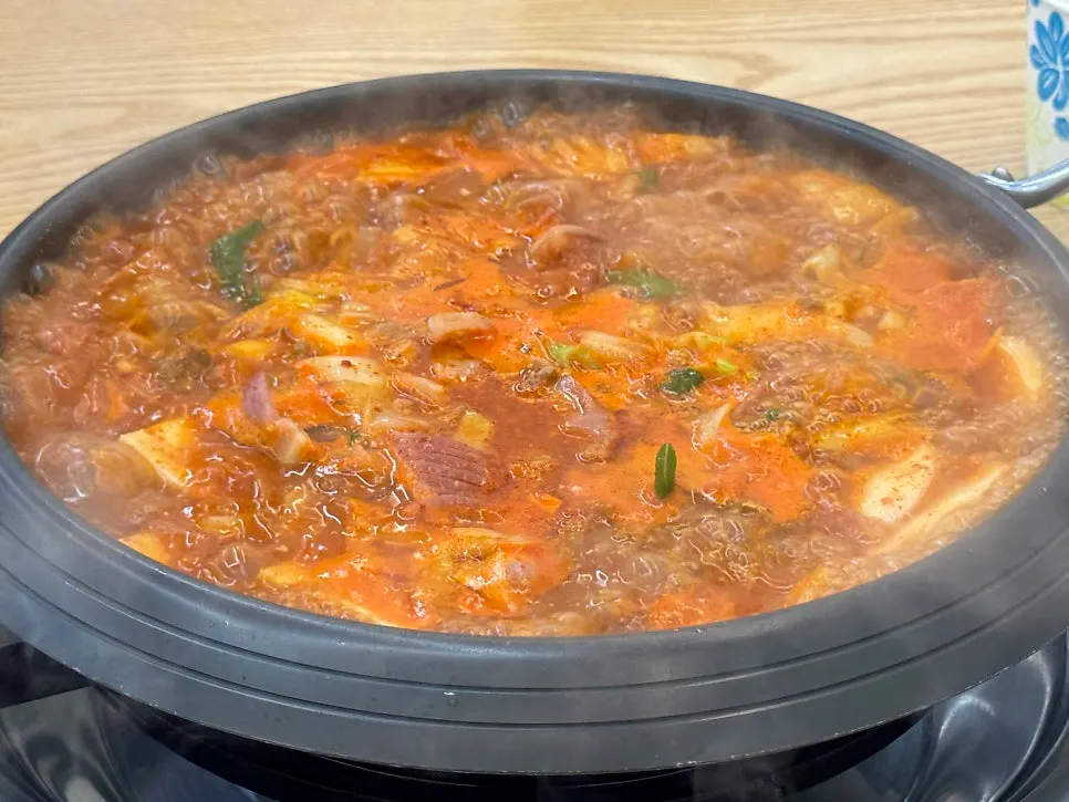 A generously loaded budae-jjigae table setting