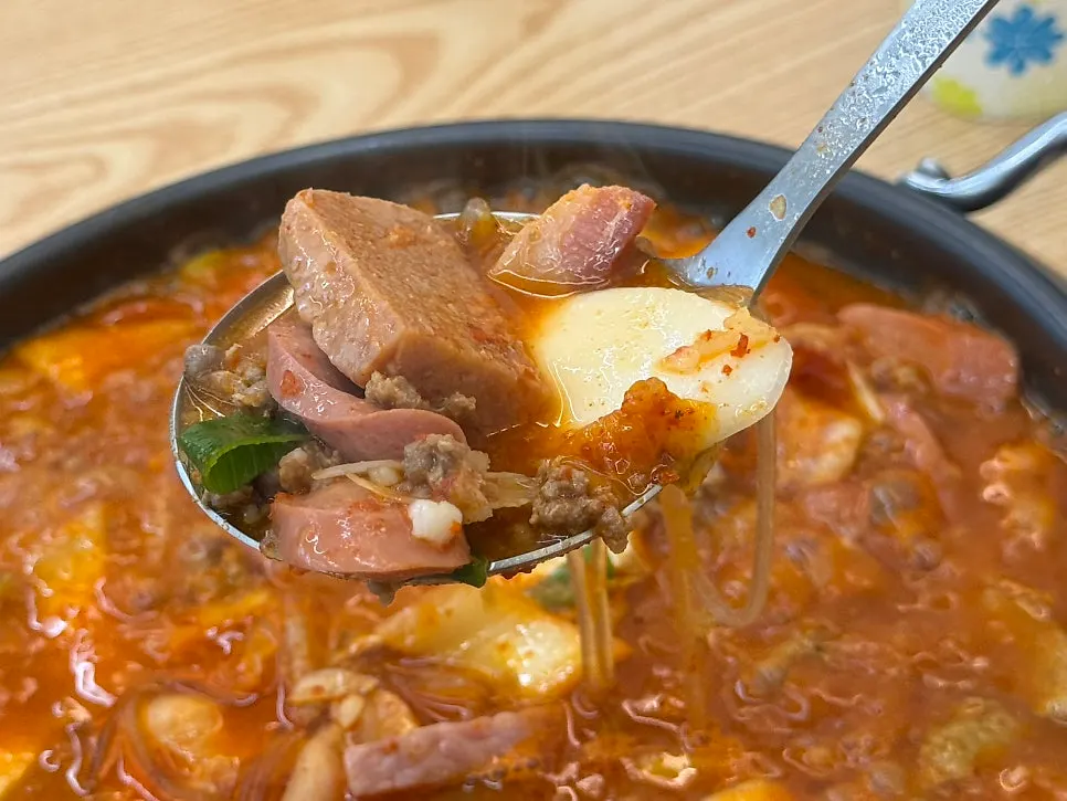 A bowl of rice alongside budae-jjigae