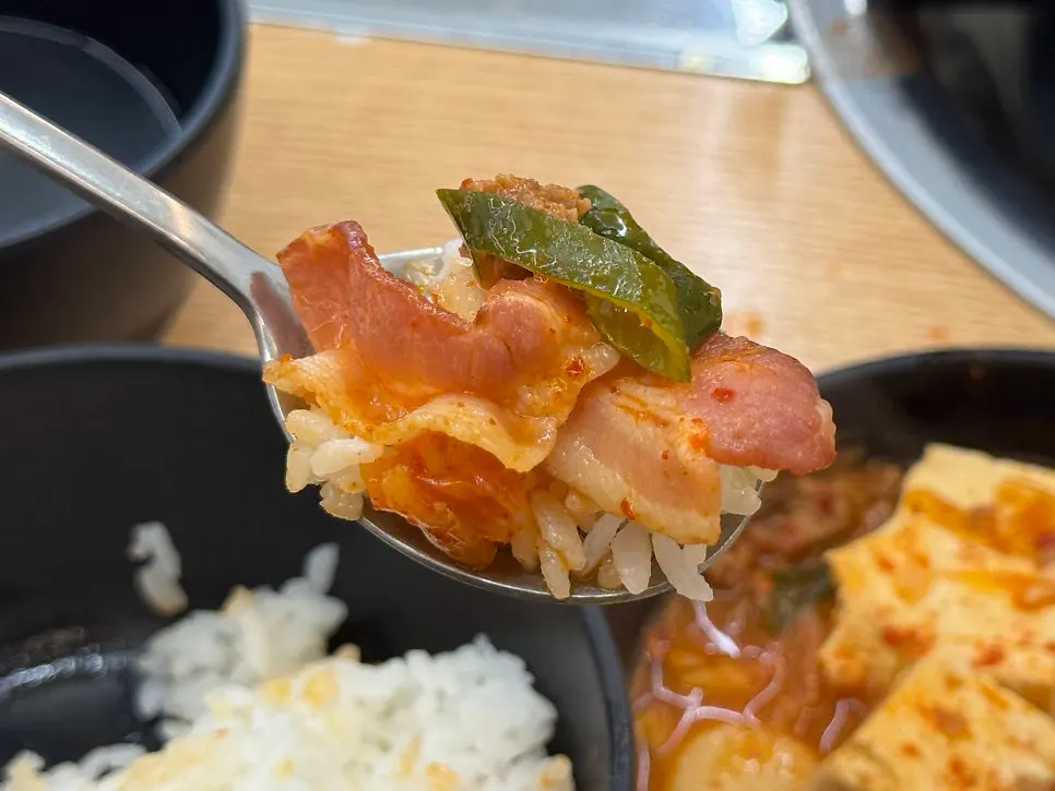 Sausage and bacon lifted out of the stew