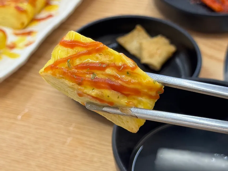 Egg roll drizzled with ketchup and mustard