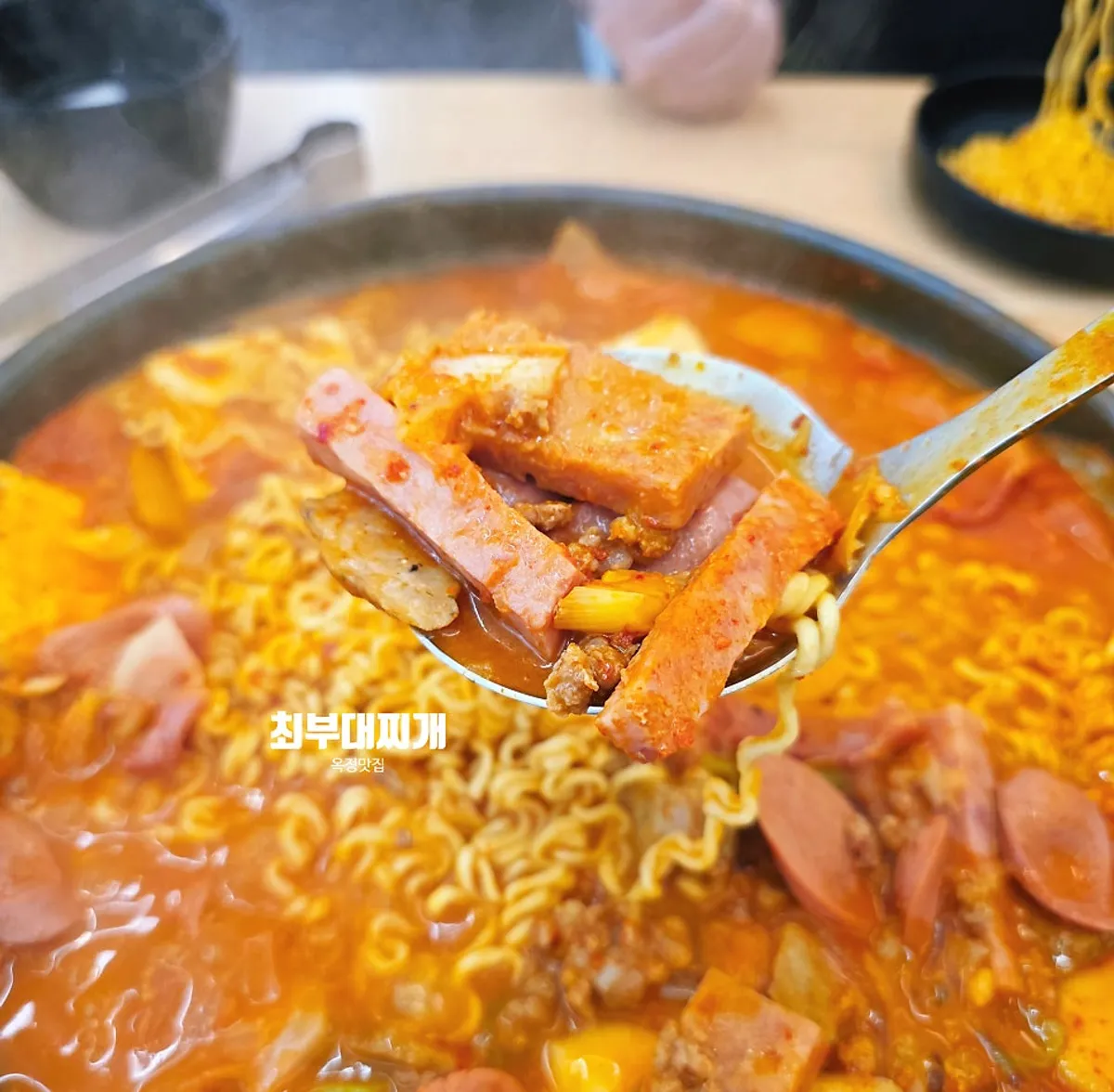 Signature budae-jjigae photo at Choi Budae Jjigae in Yangju Ojeong