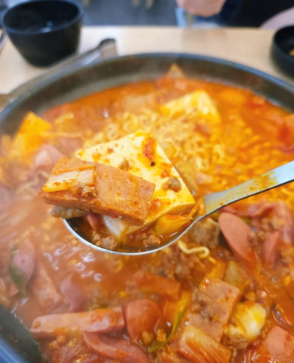 Pot of budae-jjigae packed with ingredients