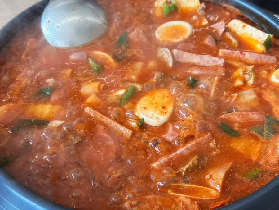Pot of budae-jjigae with ingredients before boiling
