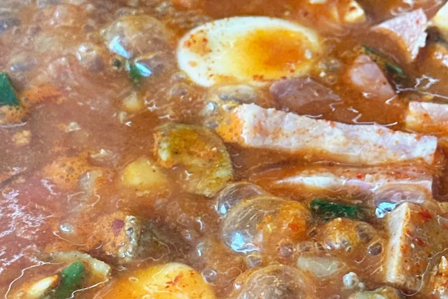 Close-up of the budae-jjigae broth as it thickens