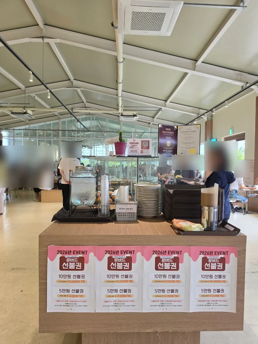 Self-serve water and cup station with a packing station