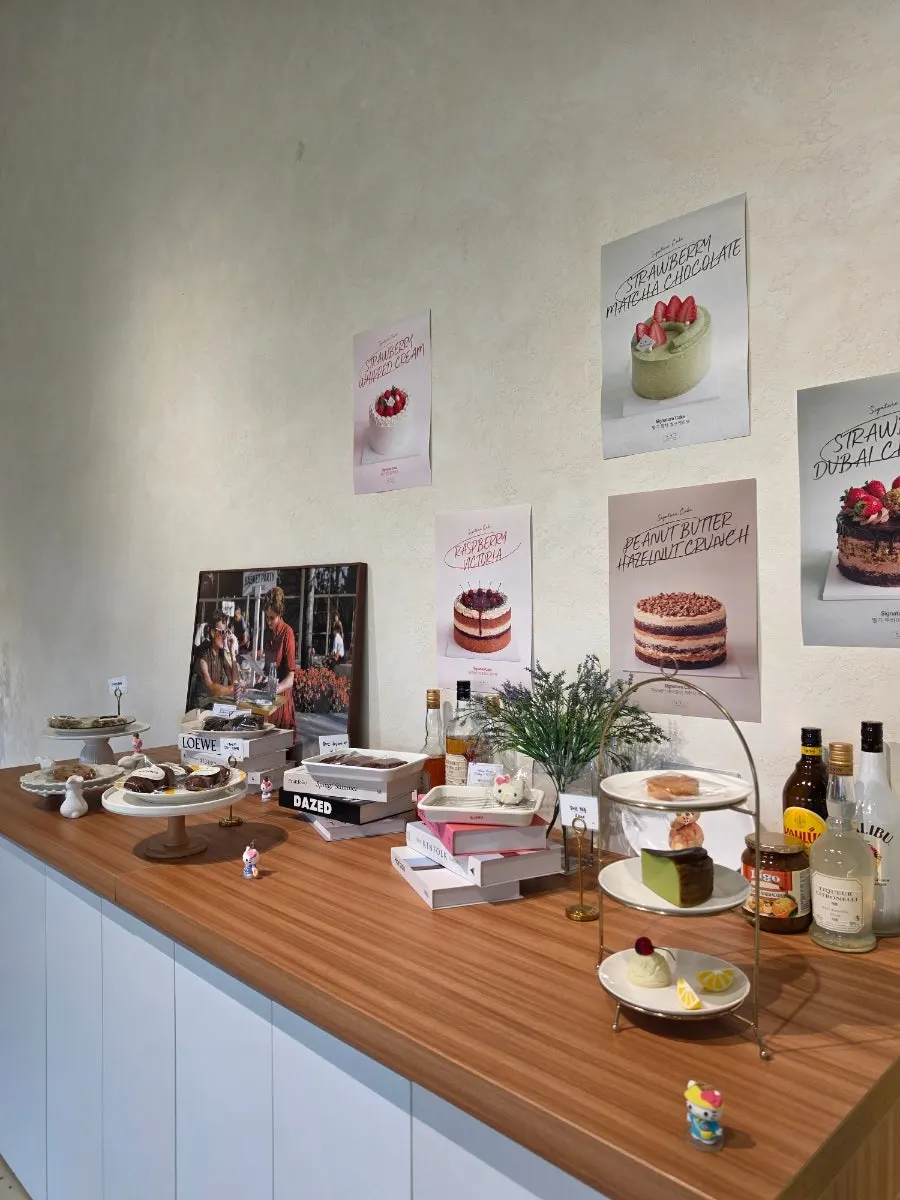 Photos of signature cakes on a shelf beside the counter