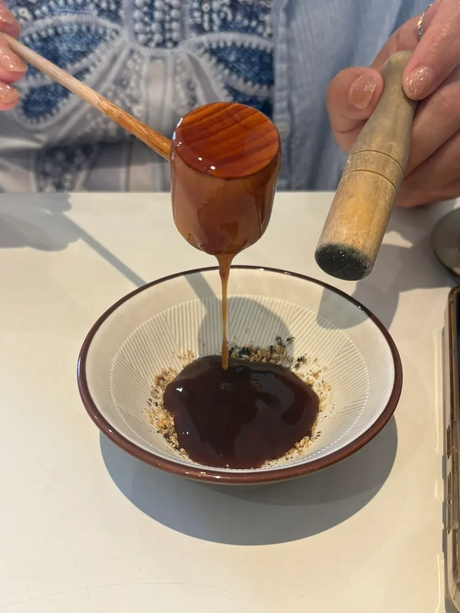 Table setting with sesame seeds and a mortar