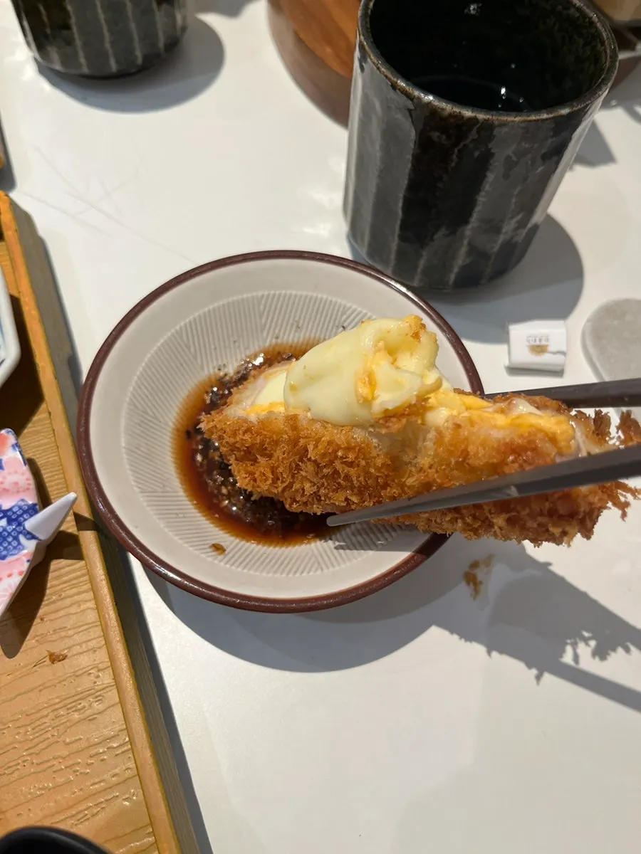 Cross-section of the cheese katsu with mozzarella and cheddar