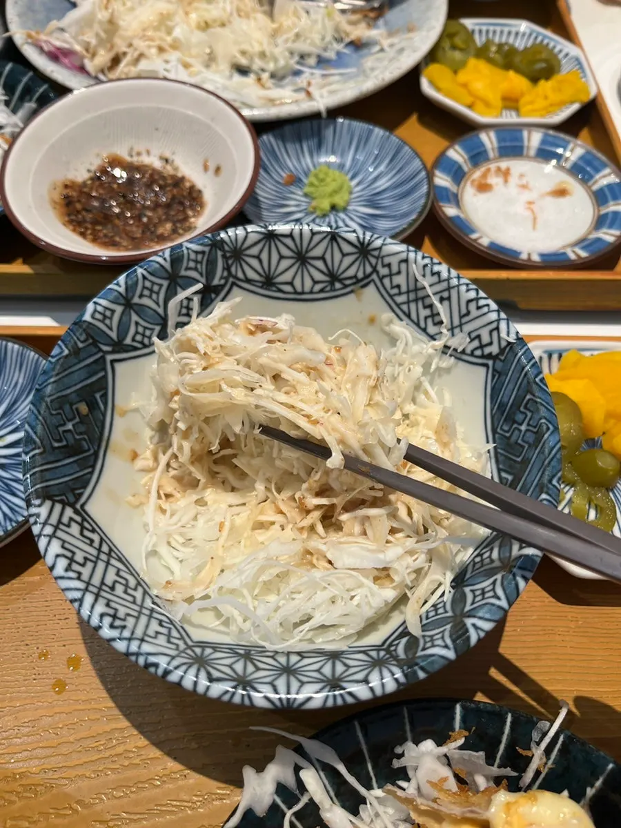 Dipping a piece of tonkatsu into the sauce