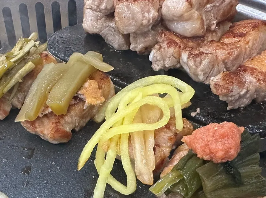 Aged kimchi grilled alongside the pork belly