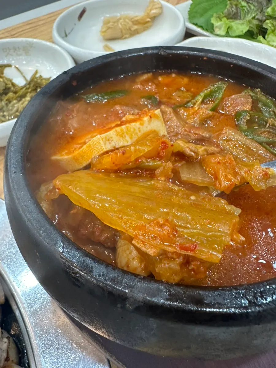 Kimchi stew bubbling in a stone pot