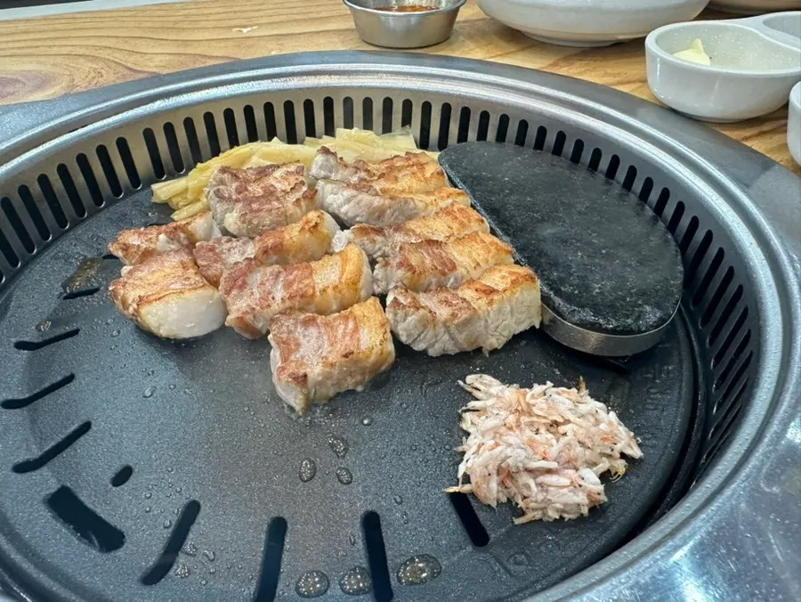 Table with pork belly and accompanying side dishes