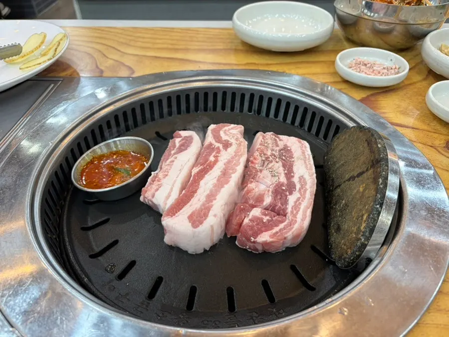 Aged pork belly placed on the grill