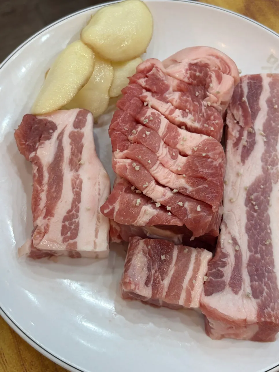 Plate of rosy raw pork belly