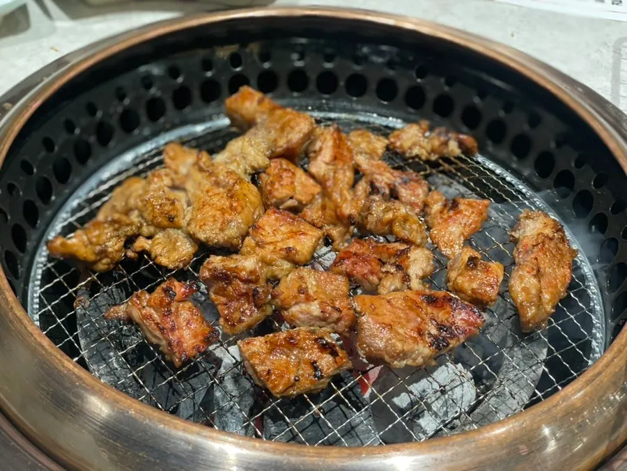 A bone-in pork galbi chunk placed on the grill