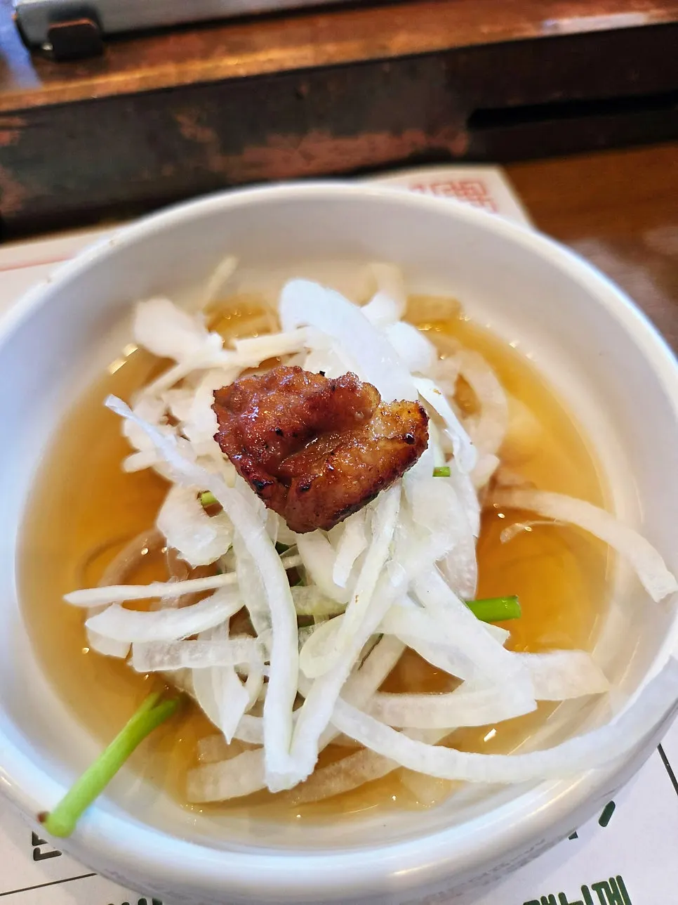 A golden-browned piece of seasoned pork galbi