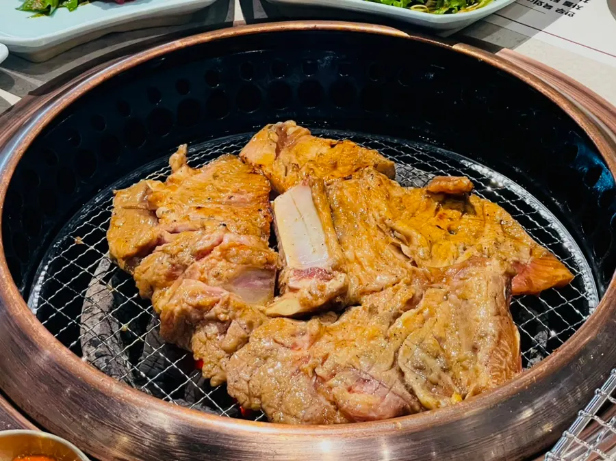 Korean pork galbi grilling over charcoal