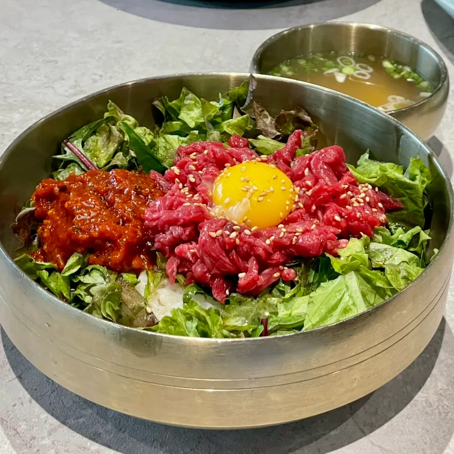 Yukhoe bibimbap topped generously with raw beef