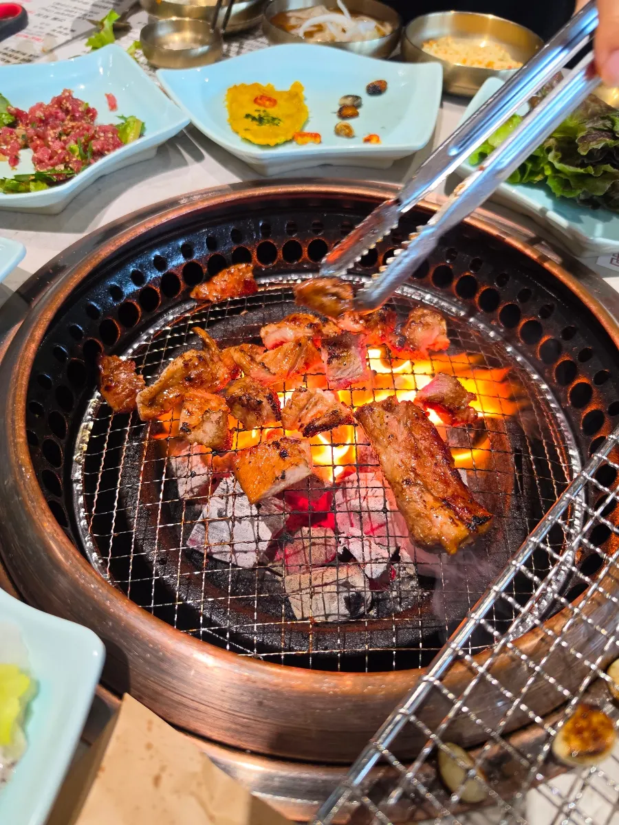 Handmade Korean pork galbi cooking over charcoal