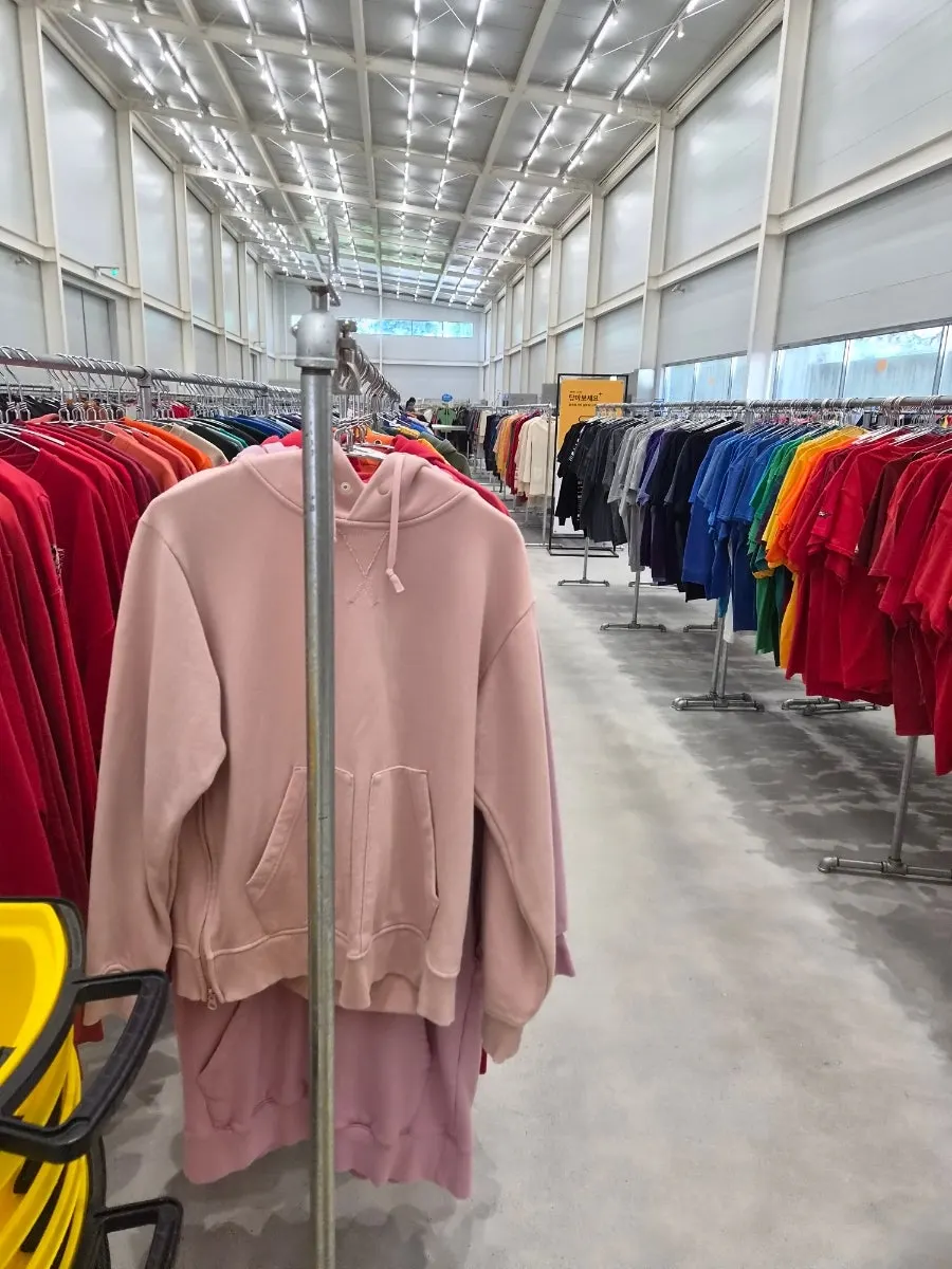 Secondhand clothes piled in a shopping cart