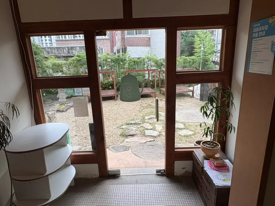 Interior with a courtyard view through large windows