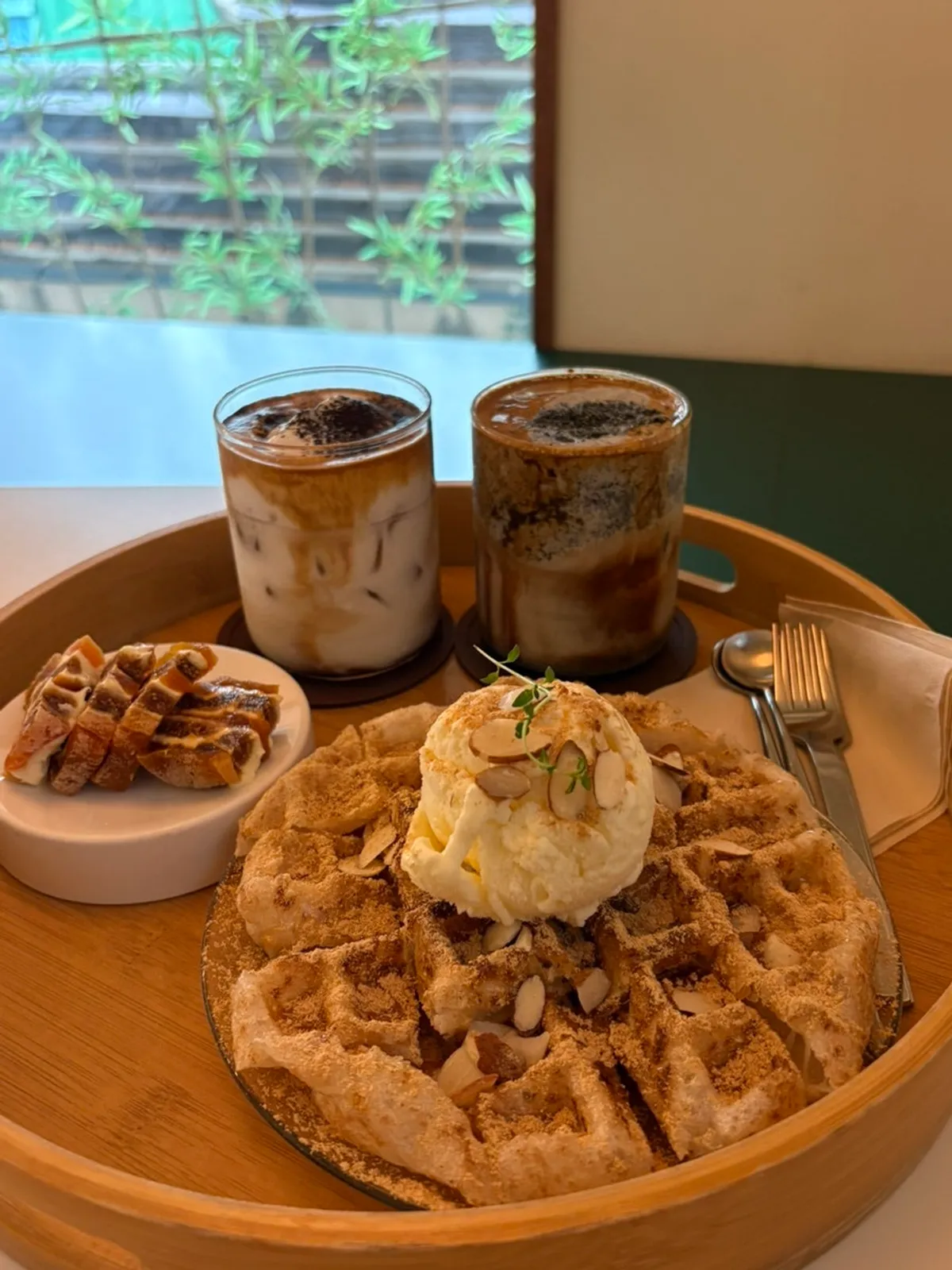 A spread of injeolmi waffle, lattes, and dried persimmon sando