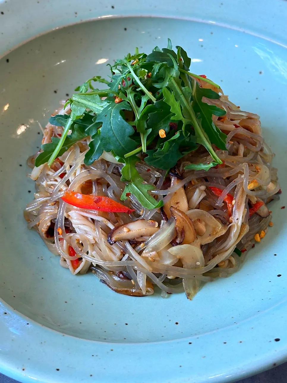 Close-up of japchae topped with mushrooms