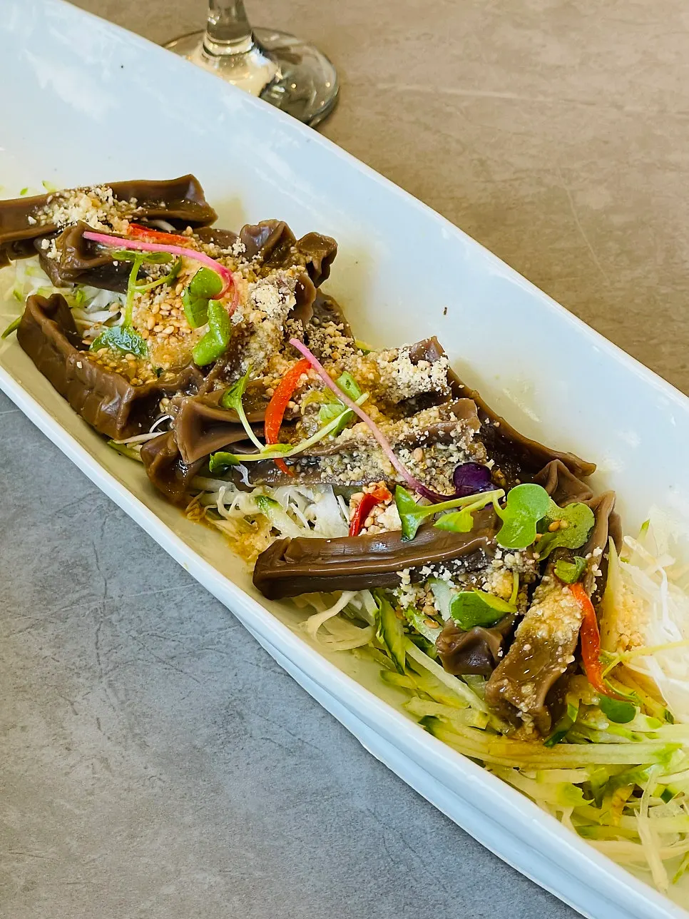 Lifting a bite of japchae noodles