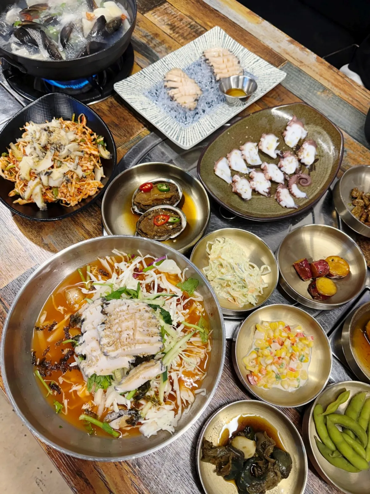 Table fully spread with the abalone course meal