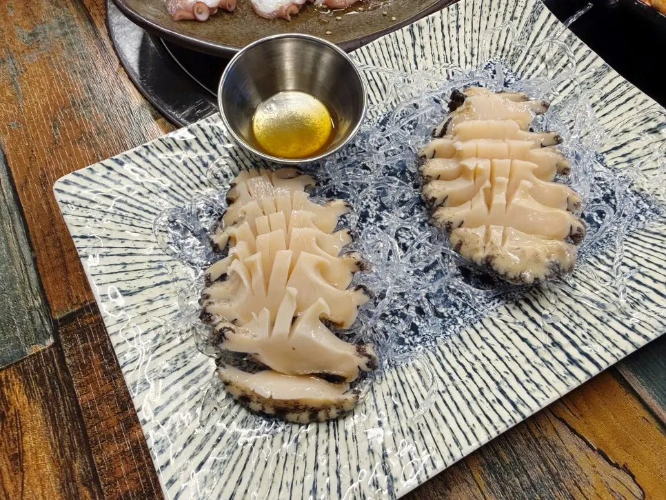 Table setting with abalone hoetguk and abalone sashimi