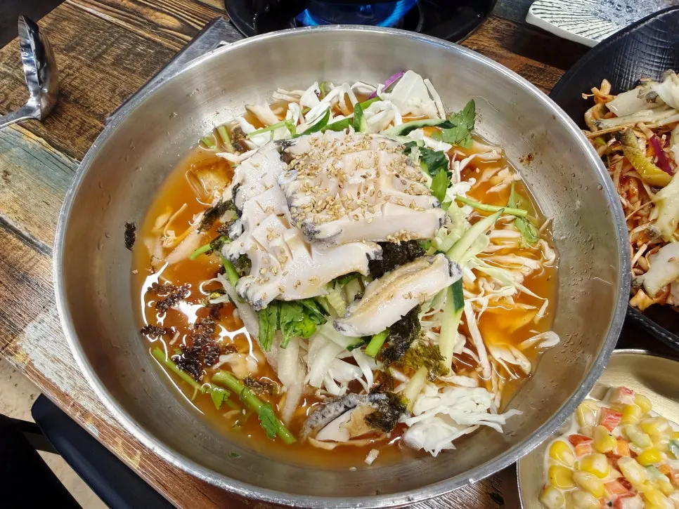 Abalone sashimi served with sesame oil